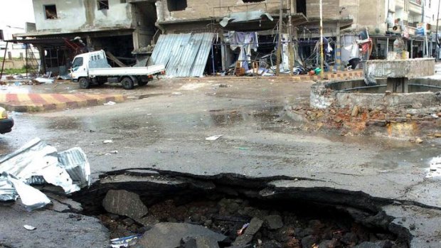 A blast site where a suicide bomber killed two people and wounded several others in the southern Syrian town of Deraa.