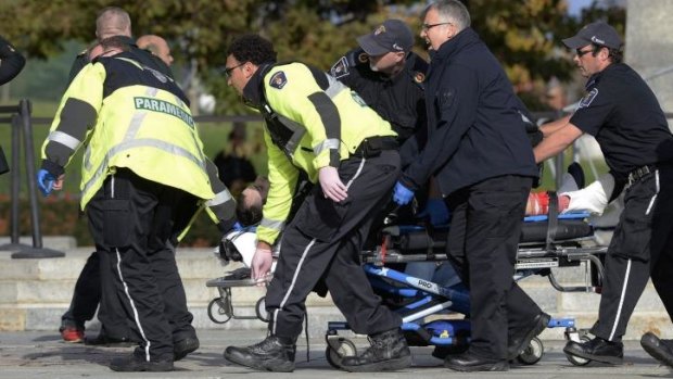 Paramedics and police rush Corporal  Nathan Cirillo for emergency treatment, to no avail.