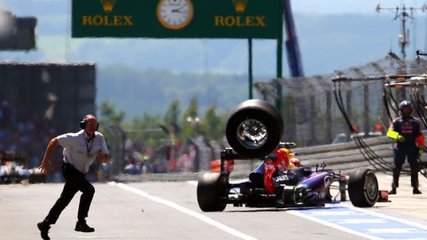 Mark Webber loses a tyre as he leaves the pits at the Nurburgring racetrack.