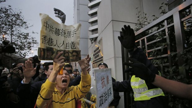 A protester shouts slogans outside the China Liaison Office in Hong Kong during a protest against the disappearance of the five men.