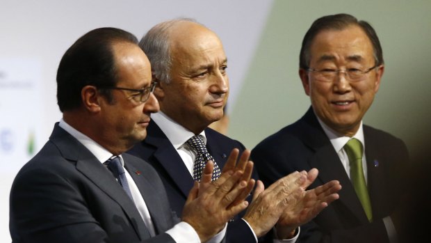 French President Francois Hollande, left, French Foreign Minister Laurent Fabius and UN Secretary-General Ban Ki-moon at the Paris climate conference on Saturday.