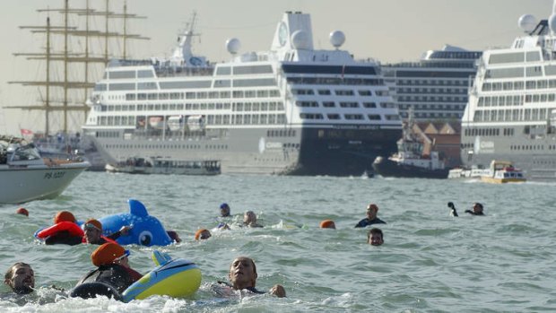 Protesters swim in the Giudecca Canal to block cruise ships inside the port in Venice.