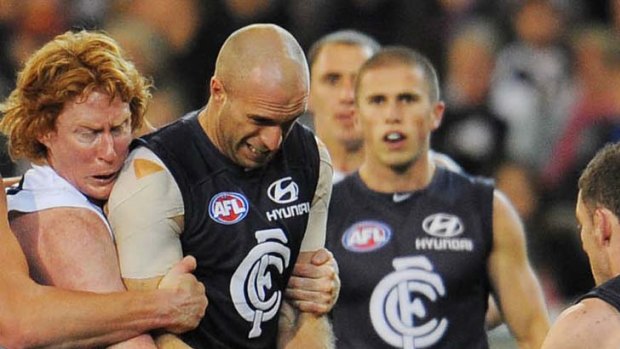 Cameron Ling wraps up Chris Judd in their 2009 clash.