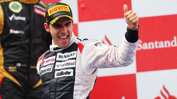 Pastor Maldonado of Venezuela and Williams celebrates on the podium after winning the Spanish Formula One Grand Prix at the Circuit de Catalunya.