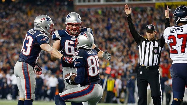 Brandon Lloyd (85) of the New England Patriots celebrates his touchdown with Wes Welker (83) and Dan Connolly (63).