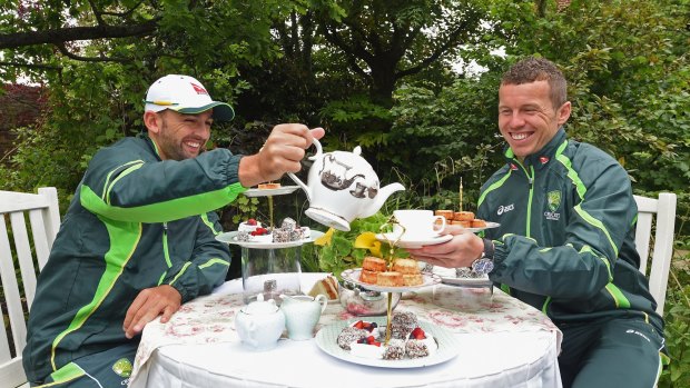 High tea maybe but sunbathing never! ... Nathan Lyon (left) and Peter Siddle enjoy afternoon tea during the Australian Ashes Squad Welcome BBQ at The Kensington Roof Garden on Tuesday in London.