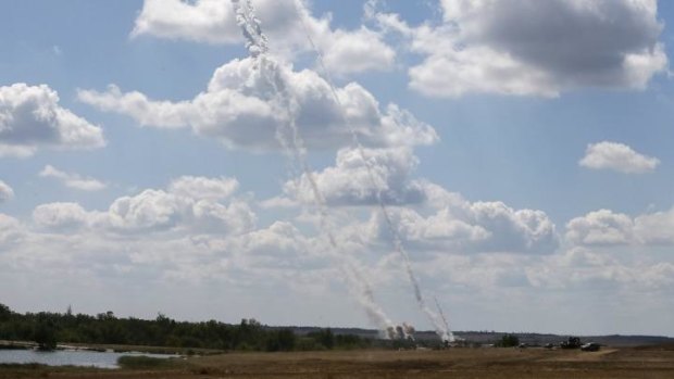 A rocket and smoke trails are seen as rockets are launched from a Ukrainian army position towards pro-Russian separatists near Debaltseve, Donetsk.