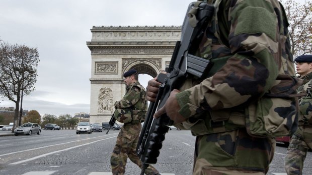 French soldiers cross the Champs Elysees avenue in Paris.
