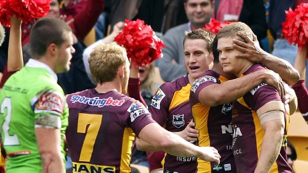 Dale Copley of the Broncos celebrates with teammates after his try against the Raiders.
