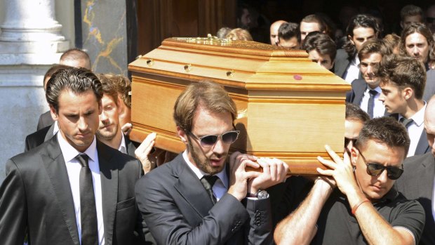 Formula One driver Jean Eric Vergne (centre), unidentified drivers and friends carry the coffin of late Marussia F1 driver Jules Bianchi at the end of the funeral ceremony.