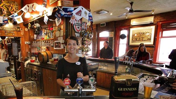 Barmaid Pip Kilgour at work in the front bar of the Rose hotel in Fitzroy which sold for $2.65m today.