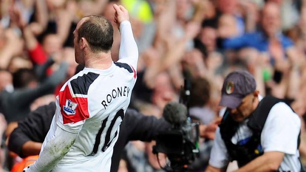 Controversial goal hero ... Wayne Rooney celebrates before swearing into a TV camera.