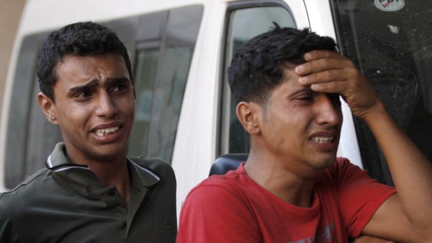 Retaliation ... relatives of the two Palestinian militants killed in Sunday's air strike mourn outside a hospital in Gaza.