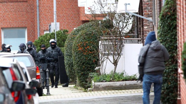 Arrests made: German special police in Alsdorf on Tuesday.