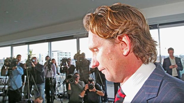 Furious: Bombers coach James Hird leaves his press conference, after attacking AFL CEO Andrew Demetriou.