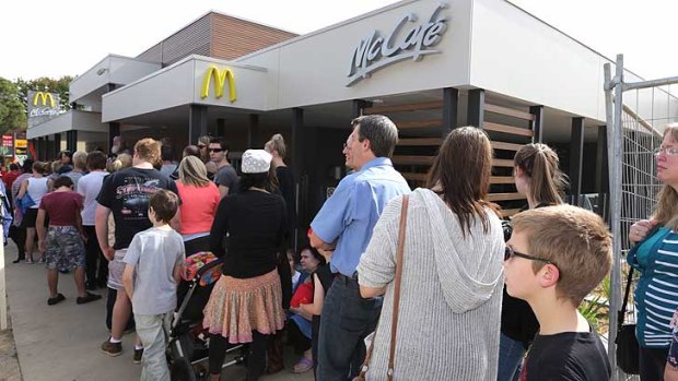 Would you like fries with that? The line-up of customers waiting to get inside the new Tecoma McDonald's far outnumbers protesters.