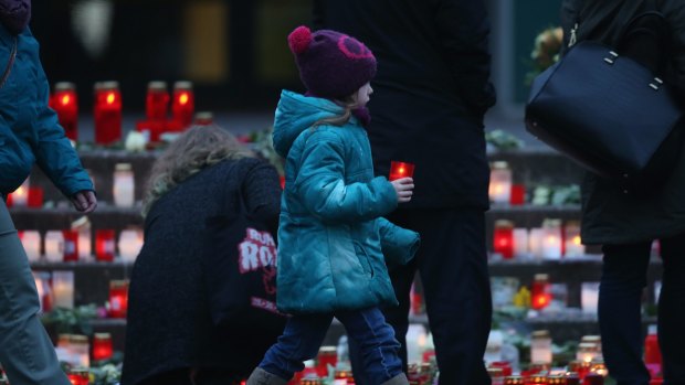 Mourners at a makeshift memorial at the Joseph-Koenig-Gymnasium high school: 16 students and two teachers from the school were on Germanwings flight 4U9525 that crashed on Tuesday. 