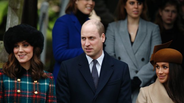 Fitting in ... Meghan Markle (right) stands with the Duchess of Cambridge and Prince William outside church.