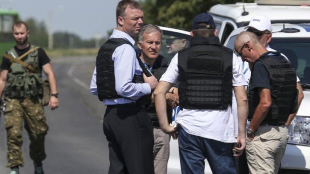 Alexander Hug (front, centre), deputy head for the Organisation for Security and Cooperation in Europe's monitoring mission in Ukraine, stands with members of his team on the way to the MH17 site on Wednesday.