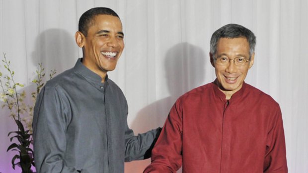 US President Barack Obama meets Singaporean Prime Minister Lee Hsien-loong at a reception for APEC leaders in Singapore last night.