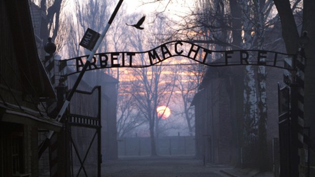Symbol of terror...police believe the sign, which stood over the entrance to the Auschwitz concentration camp, was passed through a hole in the fence. The sign, which reads "work sets you free", was made by a prisoner at the camp in 1940