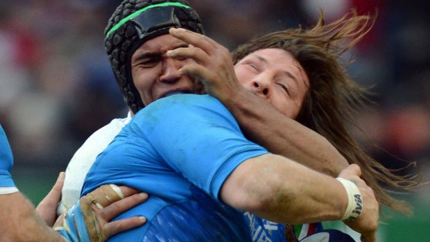 Heavy clash ... Martin Castrogiovanni of Italy is tackled by French flanker Thierry Dusautoir.