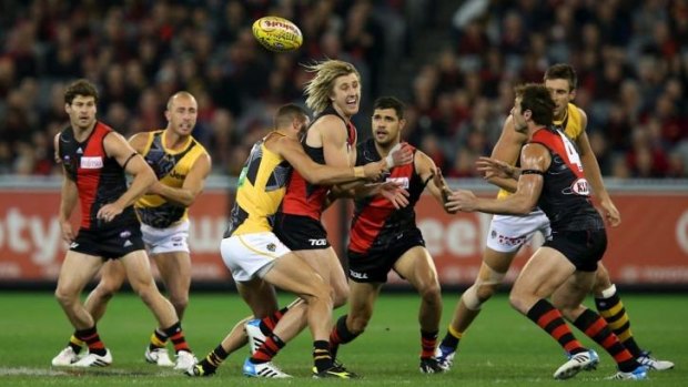 Dyson Heppell handballs under pressure after a centre clearance.