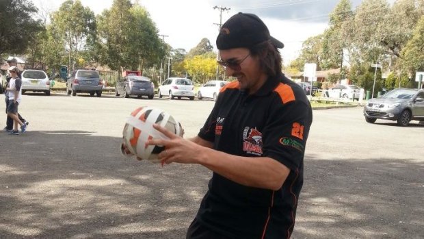Mustangs star Joey Hughes, formerly an Ice favourite, straps up the 'Stangs practice ball before their final home and away match. 