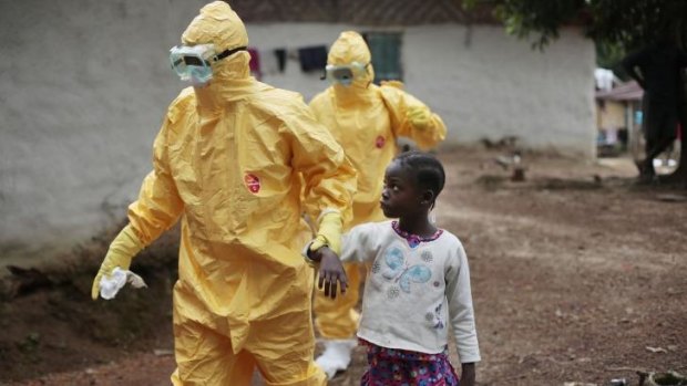 Nowa Paye, 9, is taken to an ambulance after showing signs of the Ebola infection in Liberia.