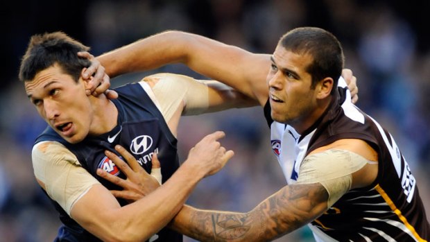 Carlton's Michael Jamison and Hawthorn's Lance Franklin jostle in a 2010 clash.
