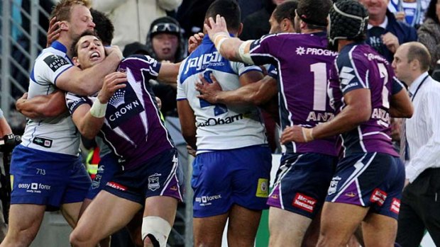 A fight erupts after Sam Perrett's try for the Bulldogs.