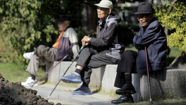 Elderly men sit on benches at Tapgol Park in the Jongro-gu area of Seoul.