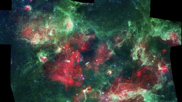  The composite infrared image, taken by NASA's Spitzer Space Telescope, shows a cloud of dust and gas 4500 light years away from earth in the constellation Cygnus.