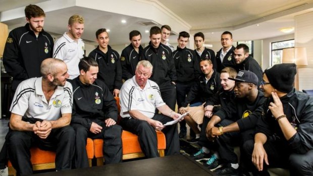 Tuggeranong United players talk strategy with coach Steve Forshaw in the lobby of the Alpha Hotel ahead of their match against Melbourne Victory.