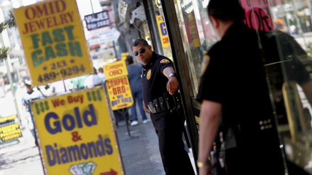 Armed security guards stand watch in front of three Los Angeles jewellery stores that have become soft targets for thieves cashing in on the high price of gold.