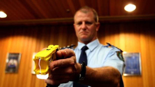 Non-lethal weapon...NSW police officer Bob O'Riordan holds Taser stungun with the double handed Glock grip. More police will undergo Taser training in the next few weeks.