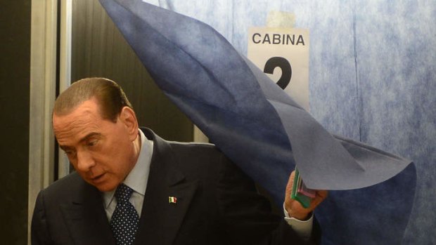 Resurgence ... Silvio Berlusconi leaves a voting booth in Milan.