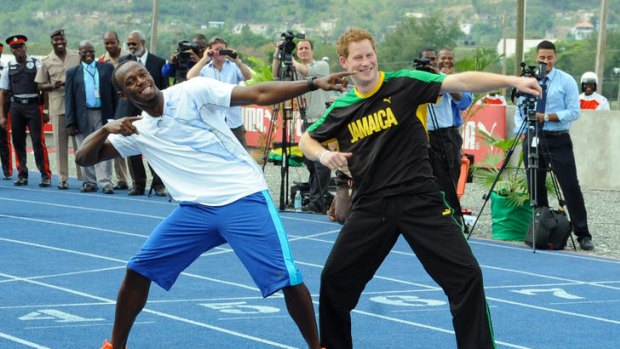 Prince Harry and Usain Bolt pose for photographers.