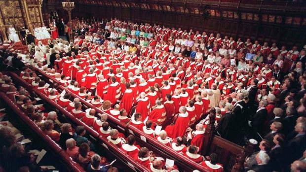 Members of the House of Lords and House of Commons crowd into the Lords debating chamber to hear the Queen's speech.