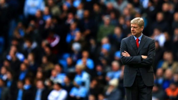Early starter?: Arsene Wenger ponders his sides 6-3 loss at the City of Manchester Stadium last December.