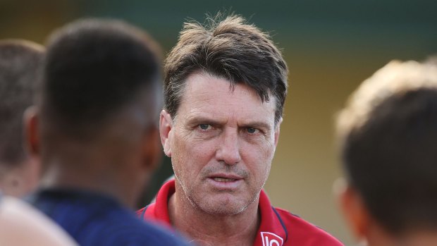 Demons coach Paul Roos speaks to his players during a break in the game.