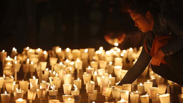 A woman attends a candlelight vigil in Ansan to commemorate the victims of the capsized ship.