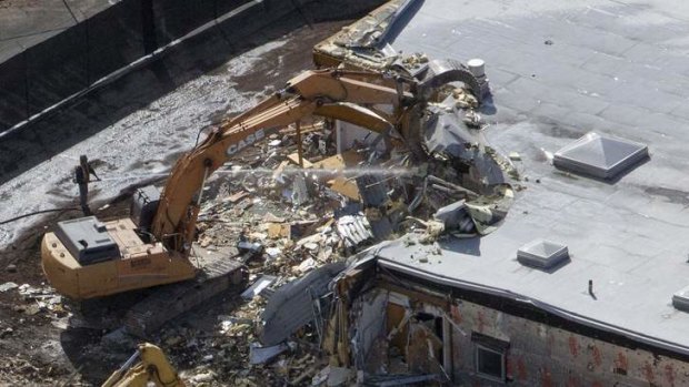 Tragic site: Workers tear down part of Sandy Hook Elementary School in Newtown, Connecticut.