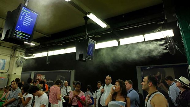 Ventilation needed: Crowds of commuters cool down under the mist generating fan system which was trialed at Town Hall Station in 2011.