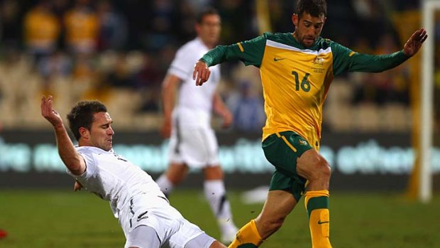 Tim Brown of the All Whites competes with Carl Valeri of the Soceroos during the International friendly in Adelaide.