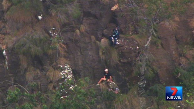 An RACQ CareFlight crew rescues a man off a cliff face at Lower Ballanjui Falls at Binna Burra.