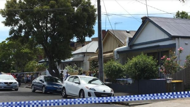 Police outside the Bendigo Street home where the man's body was found. 