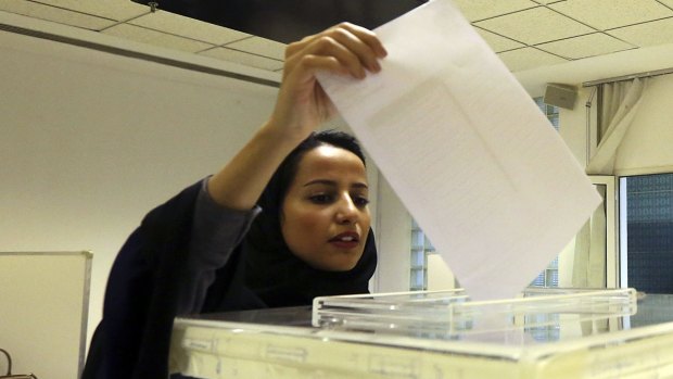 A Saudi woman votes in municipal elections in December 2015, the first where women voted and ran for election. Despite progress in gaining the franchise, women are still subject to laws that make men their guardians for basic personal decisions.