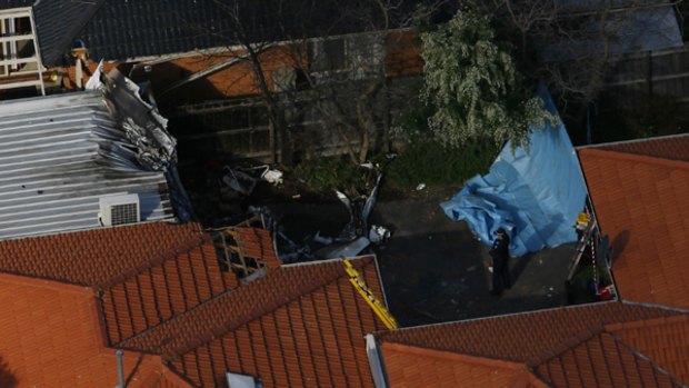 Police survey the scene of a  light plane crash in Chelthenham