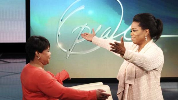 Oprah Winfrey greets her half-sister Patricia (left).